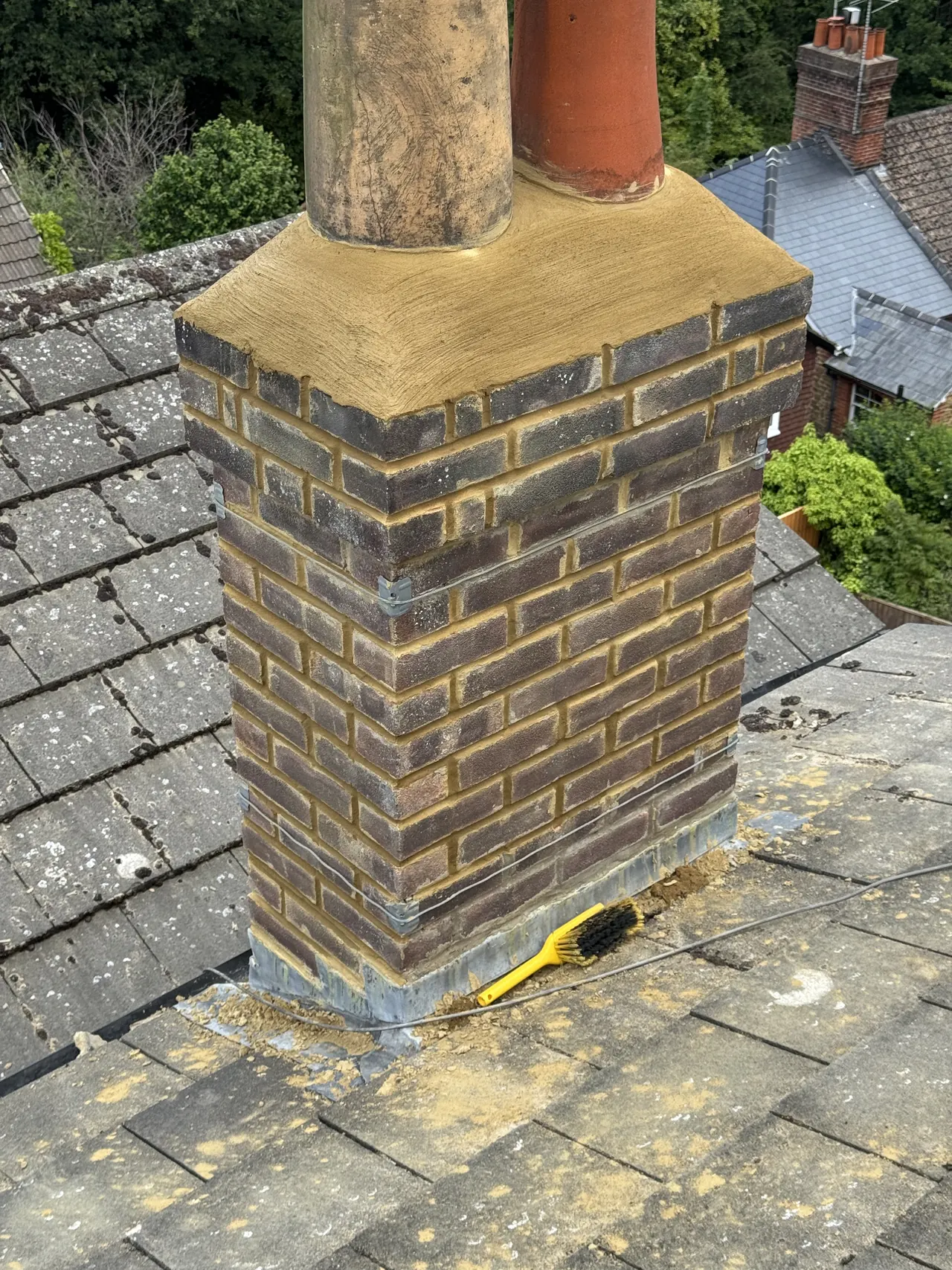 Rebuilt brick chimney stack with new flaunching, two pots and lead flashing