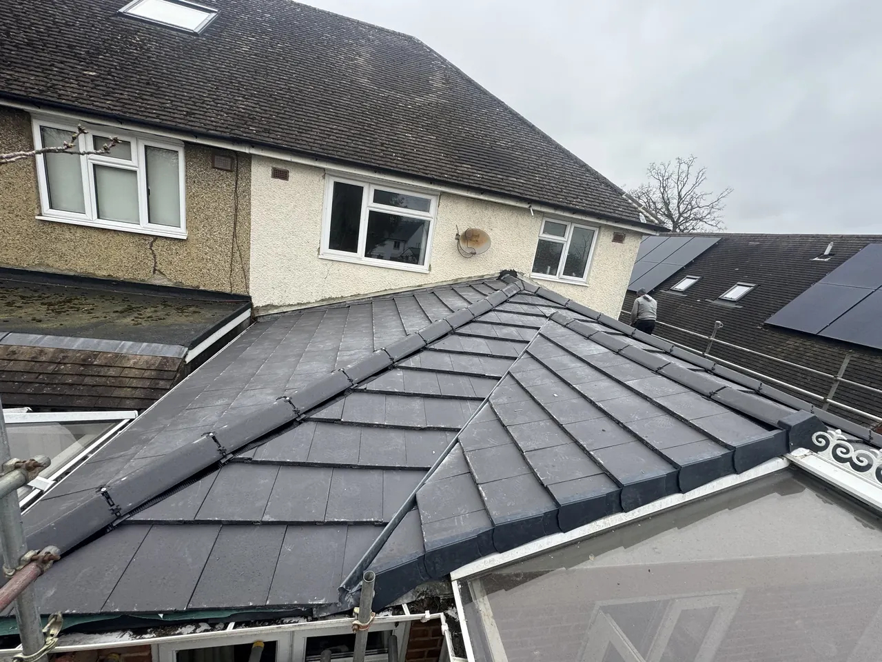 Pitched grey tiled roof over a single-storey rear extension, ridge running back to the house